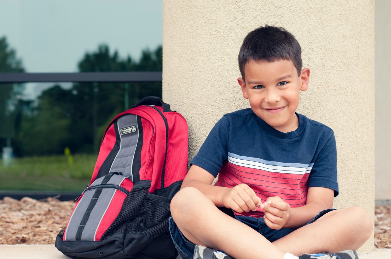 young student with his bookbag